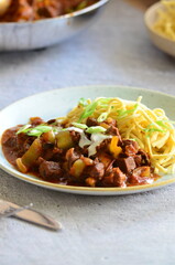 family meal background, served food, beef perkelt, spaetzle, blue plate, top view