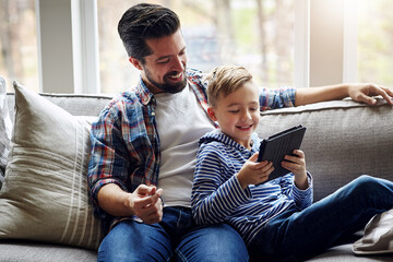 Father, son and house on sofa with tablet, family together and browsing internet for kids shows or...