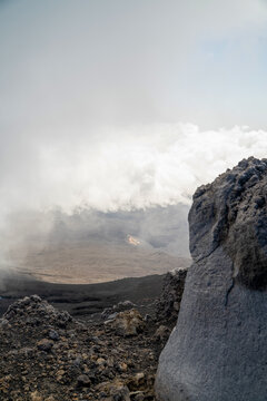 Clouds naturally formed around mount etna volcano on the top altitude with rocky formation