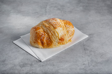 A view of a croissant with sesame seeds.