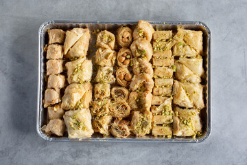 A top down view of a tray of assorted baklava pastries.