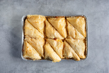 A top down view of a tray of shaabiyat pastries.