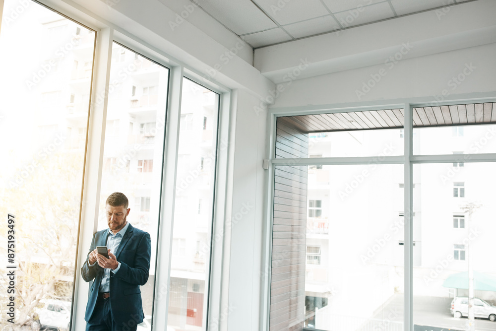Poster business, empty office and man with smartphone for email or communication and networking. entreprene