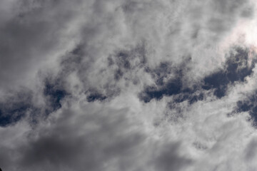 Dark sky almost completely covered with white clouds