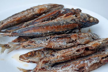 Deep fried sardines fish on white place. Asian food concept