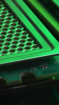 DDR RAM sticks on green electric circuit board PCB background. Double data rate random access memory. Computer memory module with contact pins. Heat spreader