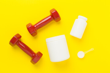 Fototapeta premium Jars with protein powder on color background, top view. Sports nutrition concept