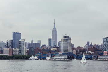 View Of The Empire State Building and Midtown Manhattan Skyline from the Hudson River with Sail Boat