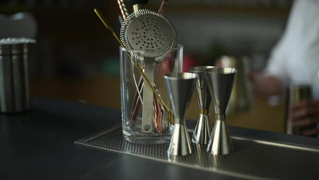 Bar Tools and Measuring Cups on a Countertop