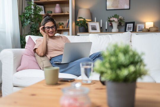 Young unemployed jobless woman sitting at home hoping for easy money and quick cash earnings from internet, work online for passive income paid surveys website surfing click for cash affiliate program