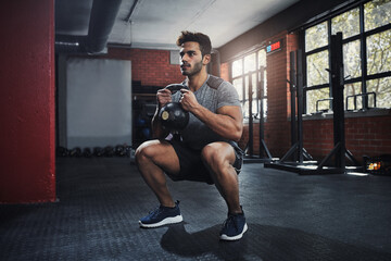 Man, fitness and exercise with kettlebell to squat in club for muscle, wellness or healthy body. Energy, training and strong person weightlifting for power, bodybuilding and workout at gym for sport