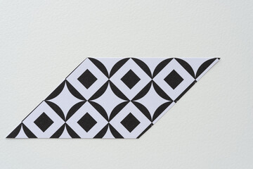 cut black and white paper shapes with square in circle repeating patterns