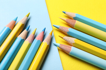 Composition with blue and yellow pencils on color background, closeup