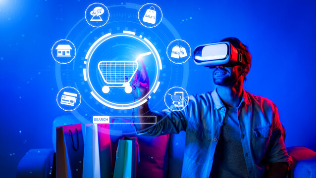 Happy man using VR headset and shopping online while sitting at sofa with shopping bags. Smart person looking at online market hologram and icon with neon background. Innovation technology. Deviation.
