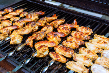 Grilled chicken wings on charcoal barbecue is American cuisine