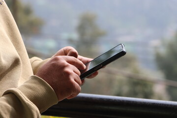 Close up of men's hands holding cell telephone with copy space