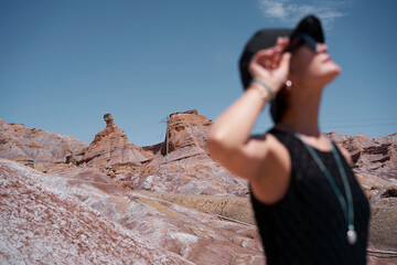 portrait of Asian beauty standing in yardang landform under blue sky
