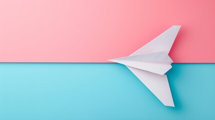 Fototapeta premium White paper airplane isolated on pink and blue background