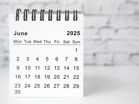 June 2025 white monthly desk calendar on a table