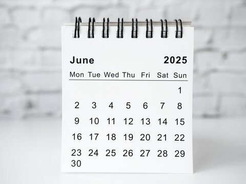 June 2025 white monthly desk calendar on a table