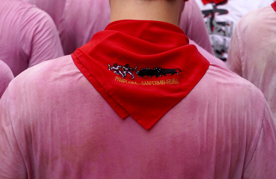 A red scarf with the emblem of a corida on the neck of a man drenched in wine. opening of the holiday: San Ferm&iacute;n in the city of Pamplona Navarra Spain on June 6, 2024        