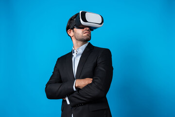 Smart business man crossing arms and standing with folded arm at white background. Professional manager looking at financial graph by using technology innovation to visit enter metaverse. Deviation.