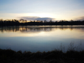 Sunrise over the lake. Beautiful nature view. Sunset on the river