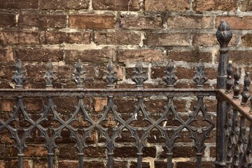 old brick wall background metal fence with iron finials 