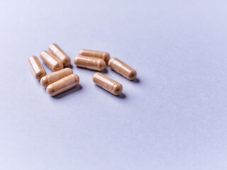 Ashwagandha (Withania somnifera) capsules. Paper background. Soft focus. Close up. Copy space.	