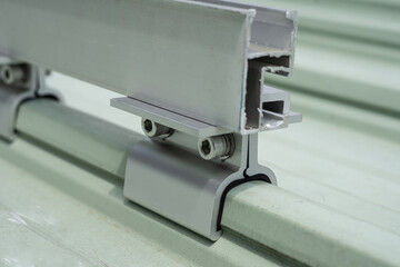 Close-up of the clamps holding the metal sheet back to the solar cell system.