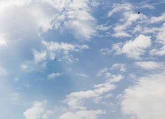 Silhouette of the MIG fighter jet in the cloudy sky. Military