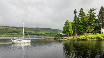idyllic Scotland, a sailingboat coming home on Loch Ness