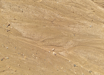 Sand on the beach as an abstract background. Sand deposits after water flow. Texture. Pattern. Selective focus