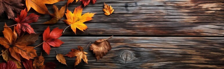 Atumnal leaves on wooden background. Autumn leaves over wooden background with copy space. Autumn maple leaves over wooden background.