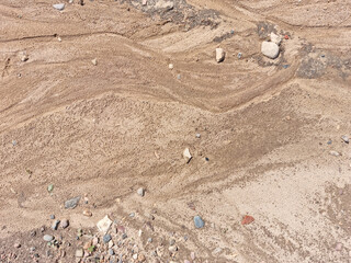Sand on the beach as an abstract background. Sand deposits after water flow. Texture. Pattern....