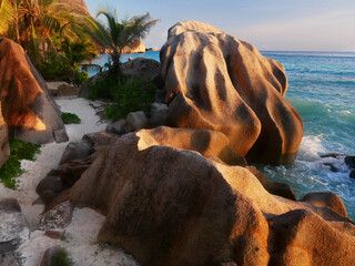 Seychelles tropical island beach and rocks at sunset