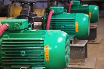 Pipes, shut-off valves and pumps of the heating system in an industrial boiler room