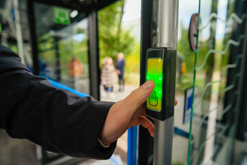 Green button for opening doors in the bus