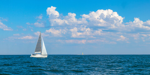 Yacht, white sailboat under head genoa and main sails sailing in an calm open sea. Cruise,...