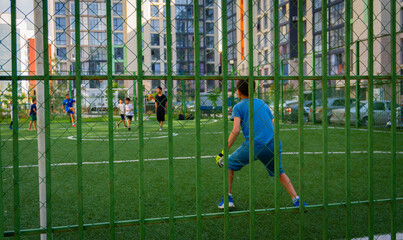 kids playing soccer in a backyard field