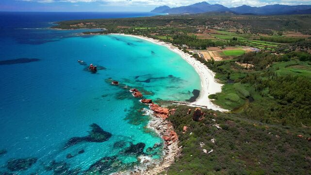 Italy . Most scenic beaches of Sardinia island (Sardegna) - beautiful Cea with red rocks (Faraglioni). on the south of Capo Bellavista near Tortoli. aerial drone 4k hd video