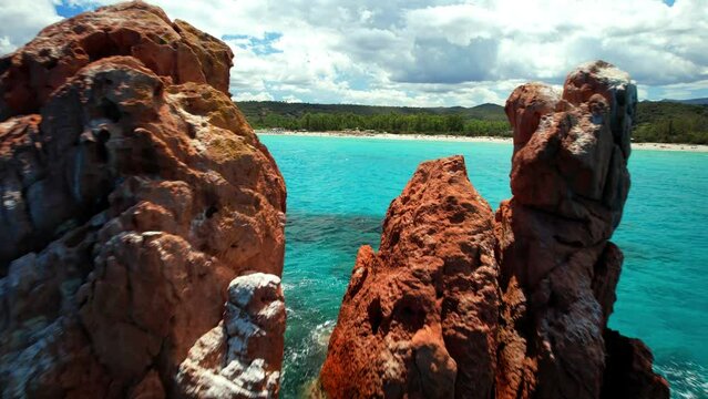 Italy . Most scenic beaches of Sardinia island (Sardegna) - beautiful Cea with red rocks (Faraglioni). on the south of Capo Bellavista near Tortoli. aerial drone 4k hd video