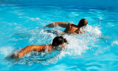 men compete swim in the water