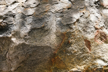 Empty grey orange sandstone wall with rust stain for abstract background and texture. Beautiful natural patterns, space for work, banner, wallpaper close up.