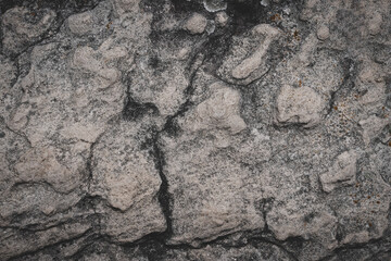 Grey black stone wall background. Gray rock with rough surface. Abstract pattern. Natural backdrop. Natural rock texture. Element, material design.