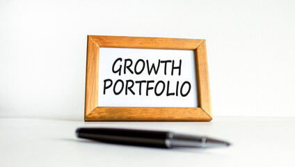 Growth portfolio symbol. Concept words Growth portfolio on beautiful wooden picture frame. Beautiful white paper background. Black pen. Business Growth portfolio concept. Copy space.