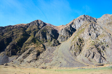 The mountains of the Caucasus. High peaks, blue sky. The season is autumn.