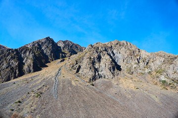 The mountains of the Caucasus. High peaks, blue sky. The season is autumn.