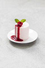 Italian dessert.  Cherry Cream pudding, Panna Cotta. Modern Cylindrical shape. With cherry sauce