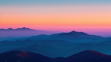 Stunning sunset view over layered mountain ranges in vibrant hues.